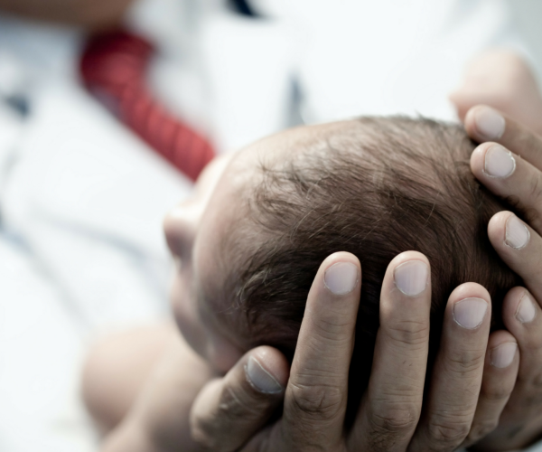Hands cradling a newborn baby