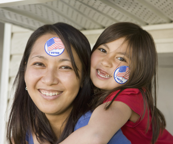 Woman and child wearing 'I voted' stickers