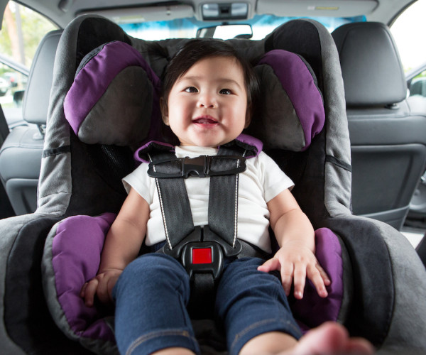 Baby buckled into auto car seat
