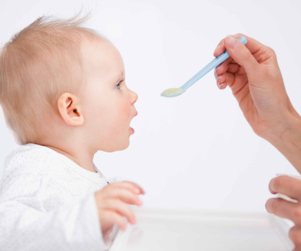 baby being fed cereal