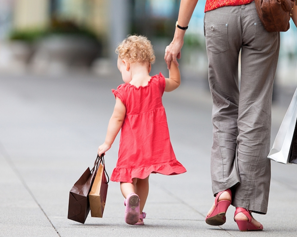 Child and adult walking, holding hands