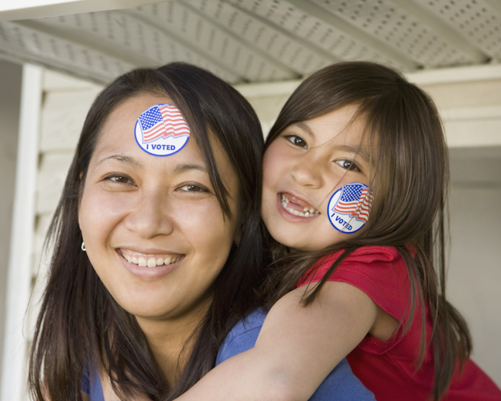 Woman and child wearing 'I voted' stickers